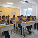Students in a modern, well-lit school classroom in India