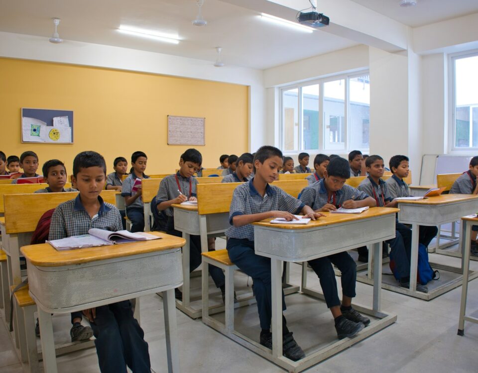 Students in a modern, well-lit school classroom in India